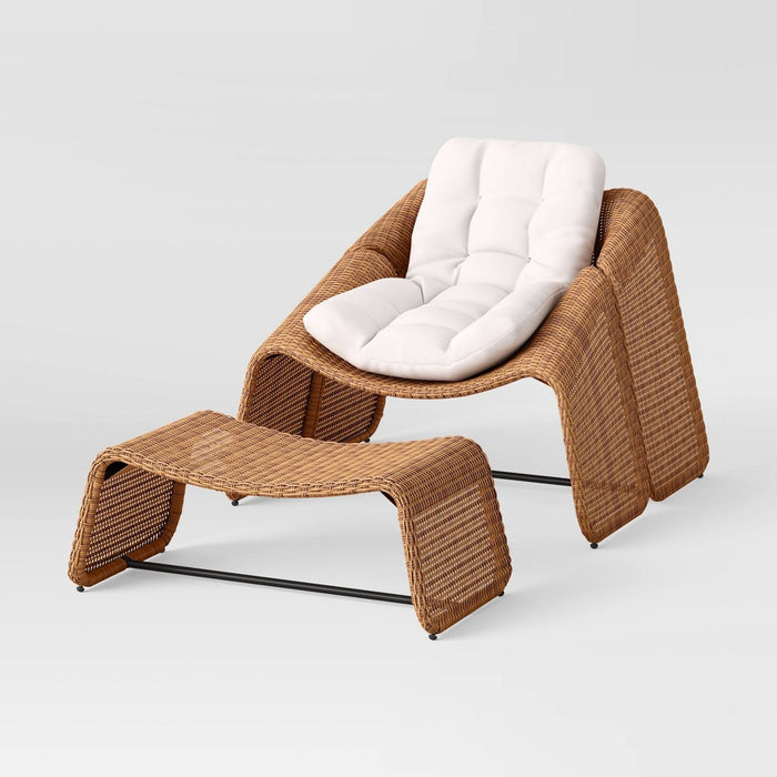 A brown wicker armless chair with a matching ottoman, featuring a steel frame and white cushions.