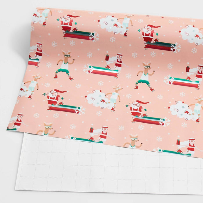 25 sq ft Roller Skating Santa Gift Wrap Pink - Wondershop