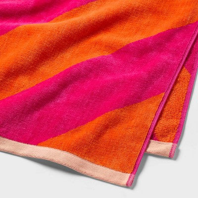 36"x72" Reversible Diagonal Striped Oversized Beach Towel Pink/Orange - Room Essentials